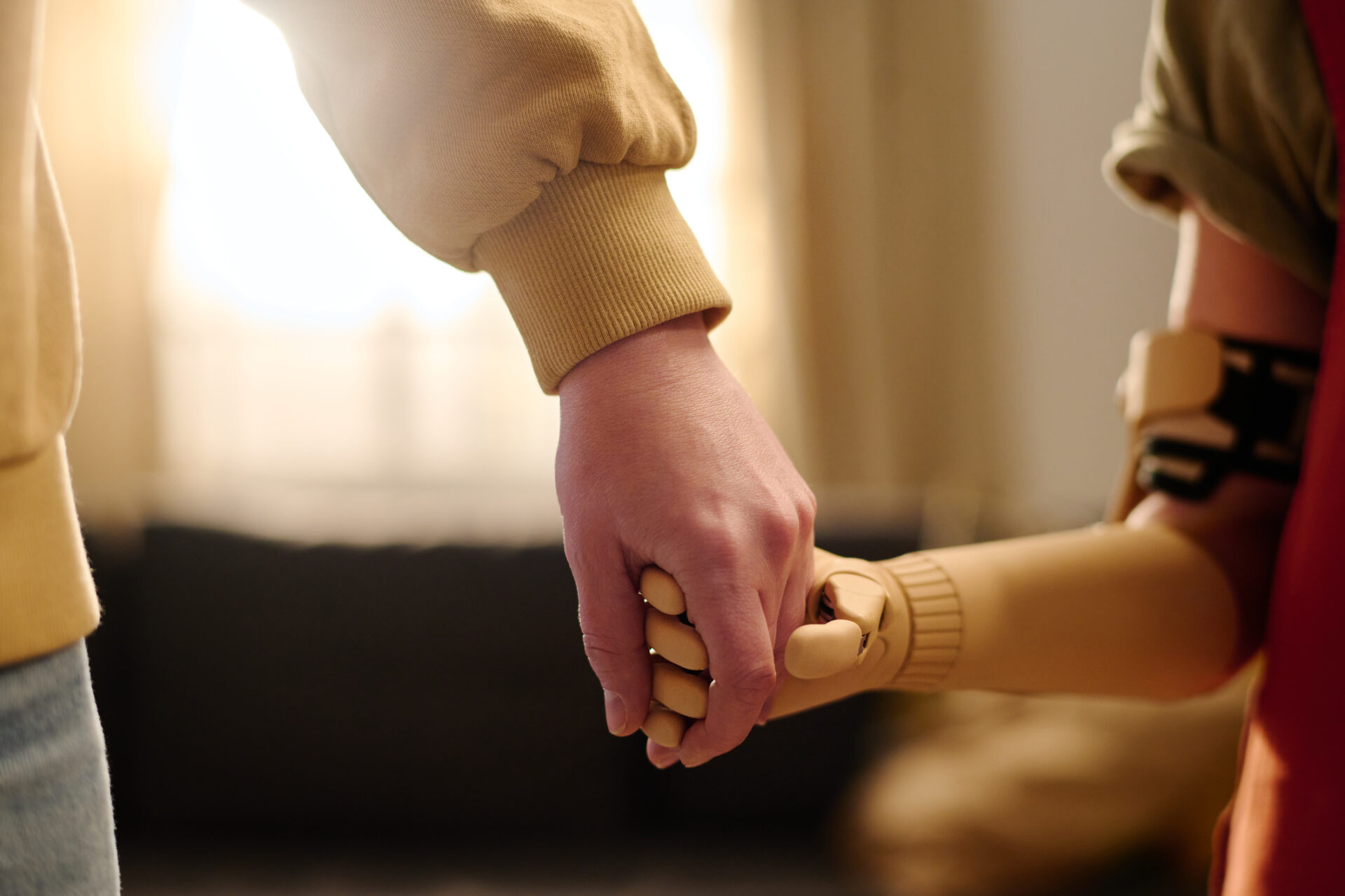 holding a child's prosthetic hand